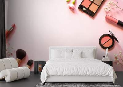 makeup professional cosmetics on pink background with flowers. flat lay with copy space. Wall mural