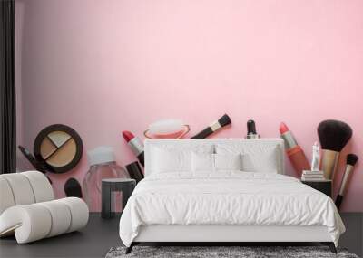 Makeup professional cosmetics on pink background. Cream, lipstick, shadow and brushes. Flat lay image with copy space. Wall mural