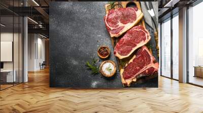 Raw meat beef steak on black top view. Wall mural