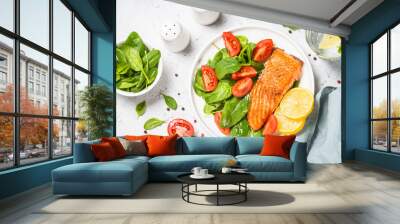 Salmon fillet with fresh salad. Baked salmon at white table. healthy food, keto diet. Healthy lunch or dinner. Wall mural