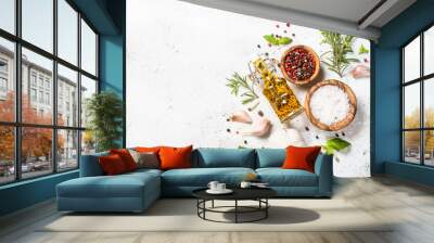 Spices, herbs and olive oil over white stone table. Wall mural