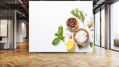 Spices and herbs over white stone table top view. Wall mural