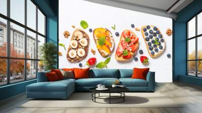 Sweet toast assortment with fresh fruit and berries on white. Wall mural