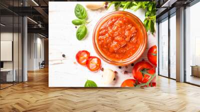 Tomato sauce. Traditional italian tomato sauce with herbs and spices at white kitchen table. Top view with copy space. Wall mural