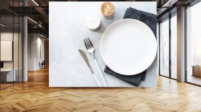 White plate and cutlery on stone table. Table setting, flat lay image. Wall mural