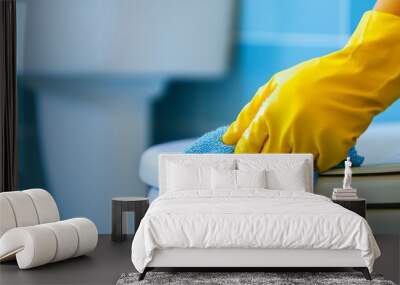 close-up of a hand in a yellow glove cleaning a toilet with a blue microfiber cloth, perfect for illustrating spring cleaning, hygiene, and home maintenance in a fresh and vibrant style Wall mural