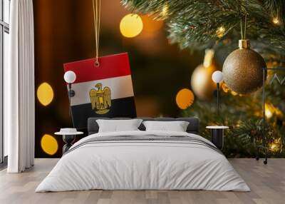 festive christmas tree adorned with an egyptian flag ornament and two golden decorations, set against a blurred background of vibrant holiday elements, capturing a joyful and colorful atmosphere  Wall mural