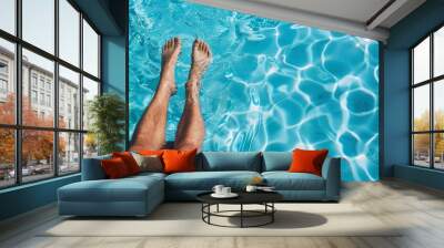 person's feet in the water of an outdoor swimming pool, with blue and white ripples visible on their skin. the background is a clear sky reflecting off the surface of the pool Wall mural