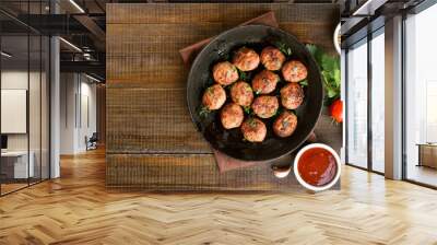 Fried meatballs in cast iron pan Wall mural