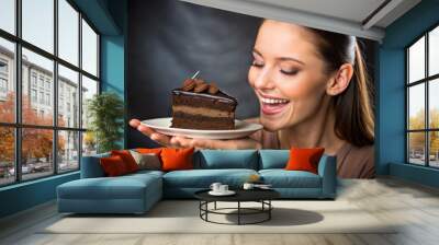 young woman eating cake Wall mural