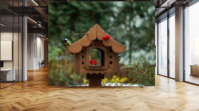 bird feeder in autumn, autumn garden birds peck food from bird feeder Wall mural