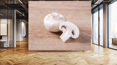 White champignons cut on wooden table in kitchen Wall mural