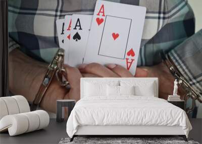 Handcuffed hands with playing cards and casino chips Wall mural