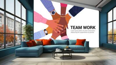 Team work concept. Vector illustration of young diverse business people putting their hands together. Place for your text. Isolated on white. Wall mural