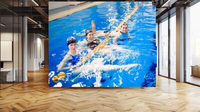 A group of girlfriends in the sports pool. Friends have fun on the training. Wall mural