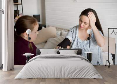 Measuring the pressure of a pregnant woman at home. Poor well-being of a pregnant woman. Wall mural