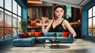 Portrait of beautiful woman holding glass of martini Wall mural