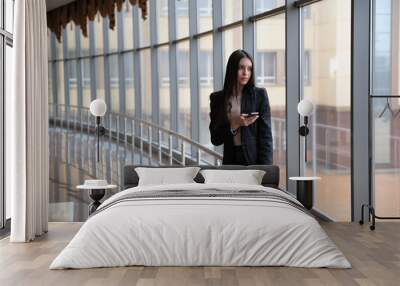 Young brunette woman is looking through the window on the planes Wall mural