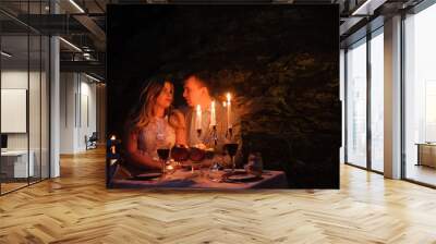 young couple enjoying a romantic dinner by candlelight, outdoor Wall mural