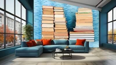 Open book, stack of hardback books  on blue cloth. Back to school. Copy space Wall mural