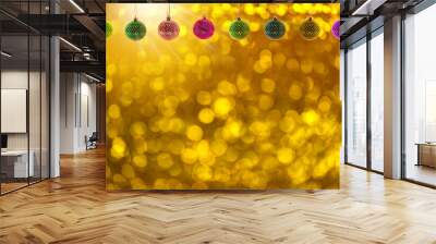 multi colore hanging  christmas balls on gold colored blurry bokeh background. Wall mural