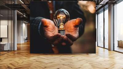 Light bulb in hand of man, innovative business idea, motivation for  success, innovation, energy save concept. Wall mural