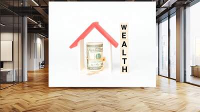 A picture of house miniature and fake money with wooden block written wealth. Wealth management concept. Wall mural