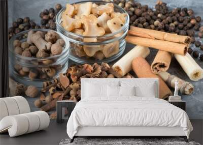 A glass jar filled with dried fruits, herbs, and spices  Wall mural