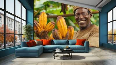 African male farmer smiling holding cocoa fruit Wall mural