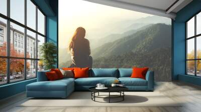 silhouette woman sitting on mountain in morning and vintage filter Wall mural