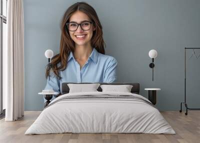 Happy young smiling confident professional business woman wearing blue shirt and glasses, happy pretty female executive looking at camera. Wall mural