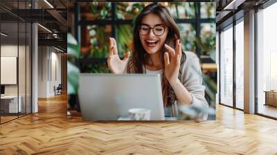 Happy young woman student having video call on laptop computer. Image of beautiful girl play notebook. Wall mural