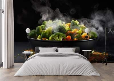 The steam from the vegetables carrot broccoli Cauliflower in a black bowl, a steaming. Boiled hot Healthy food on table on black background. copy space for text. Wall mural