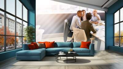 a group of four business executives conducting a meeting in a modern office space with bright copy s Wall mural