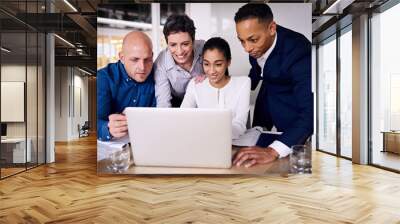 group working together to go over year end financials to determine the coming years budget as accurately as possible Wall mural