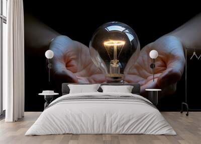 Two hands holding a bright light bulb Wall mural