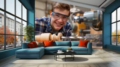 Young male carpenter working in a carpenter shop Wall mural