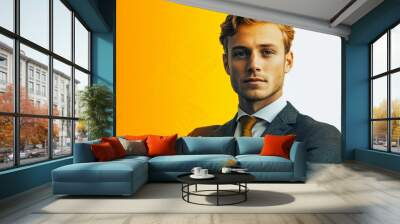 A man in a suit and tie is standing in front of a yellow background Wall mural