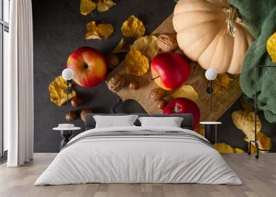 Autumn meal apples, nuts, pumpkin and yellow leaves. Dark backgr Wall mural