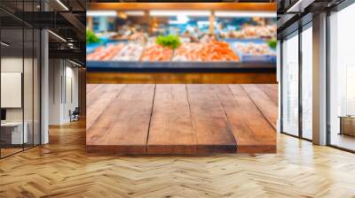 Wooden Tabletop with Blurred Seafood Market Background. Wall mural