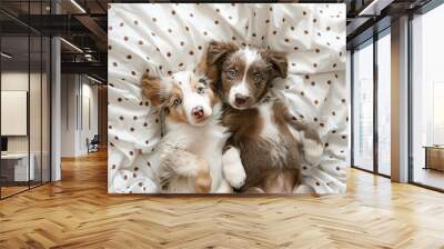 two dogs are laying on a bed together Wall mural