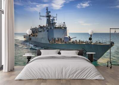 Grey modern warship sailing in the sea Wall mural