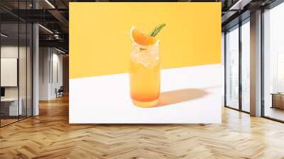 Cold and refreshing orange punch cocktail with orange slice on yellow background. summer drink. Wall mural