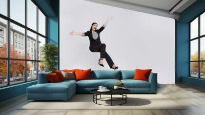 Young beautiful smiling asian businesswoman floating in mid-air and announcement something isolated on white background. Wall mural