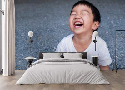 Asian cute little child boy laughing with mouth open wide, seeing whitening teeth. Happy Kid in white shirt enjoy in funny shot in relaxing day. Wall mural