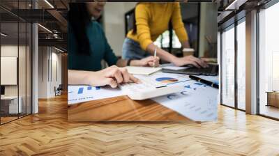 Business woman team collaboration discussing working analyzing with financial data and marketing growth report graph in team Wall mural