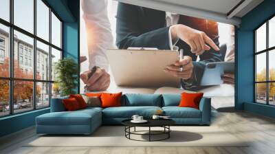 Cropped shot of diverse coworkers working together in boardroom, brainstorming, discussing and analyzing business strategy. Wall mural