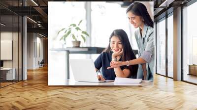 two young businesswoman meeting and discussing about new business project plan, using computer analy Wall mural