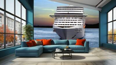 Luxury cruise ship sailing from port on sunset. Wall mural