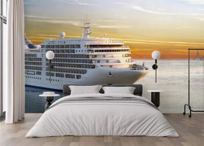 luxury cruise ship sailing from port on sunset Wall mural